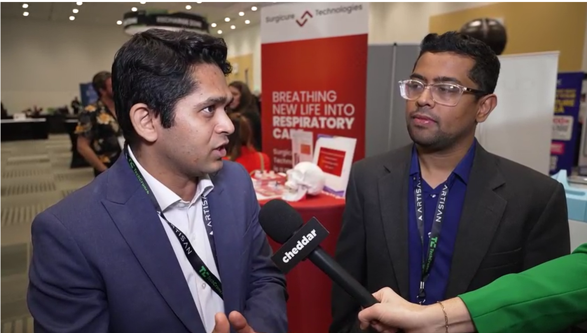CasNx representative speaking into a Cheddar microphone with a colleague beside him